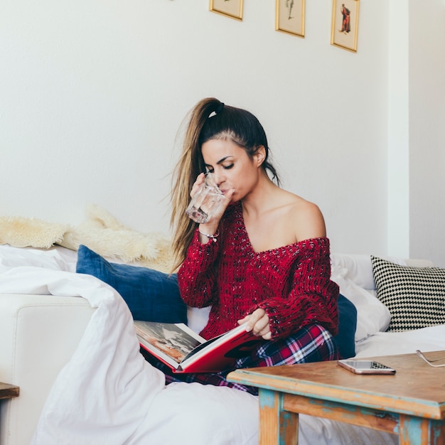 Attractive woman reading and drinking Free Photo