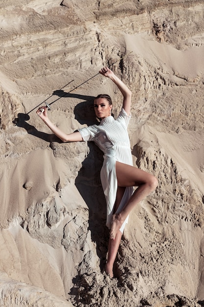 Premium Photo Attractive Woman With Sword In Total White Outfit Fashion Shoot In Desert