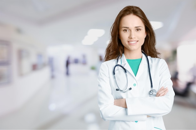 Premium Photo | Attractive young female doctor with blurred hospital ...