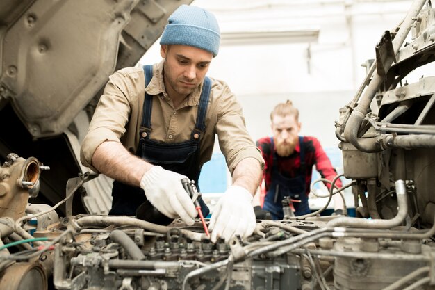 Premium Photo | Auto mechanic repairing truck