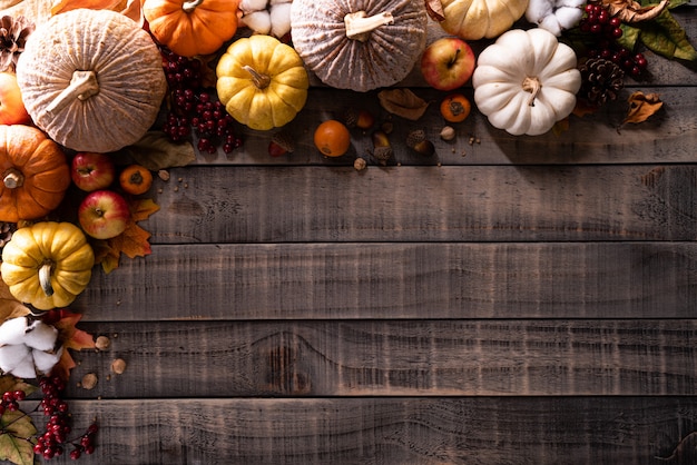 Premium Photo | Autumn maple leaves with pumpkin on wooden background ...