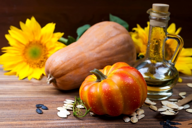 Autumn still life with pumpkins, oil and sunflowers Premium Photo