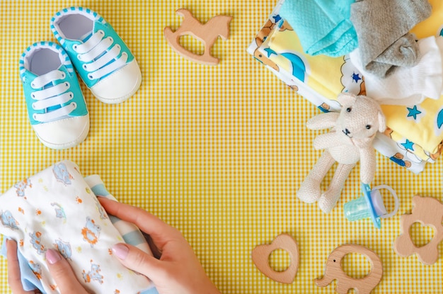 Premium Photo | Baby accessories for newborns on a colored background.