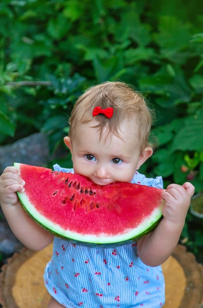 Premium Photo | Baby eats watermelon in summer. selective focus.