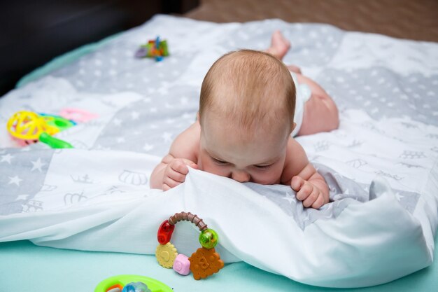 Premium Photo | Baby girl 3 months old is lying on the bed. baby ...