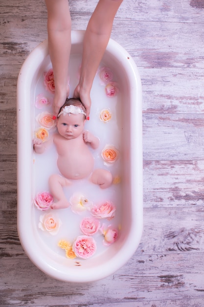 Premium Photo | Baby girl child having a milk bath with ...