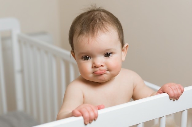 Baby Girl In A Diaper Playing In The Crib Photo Premium Download