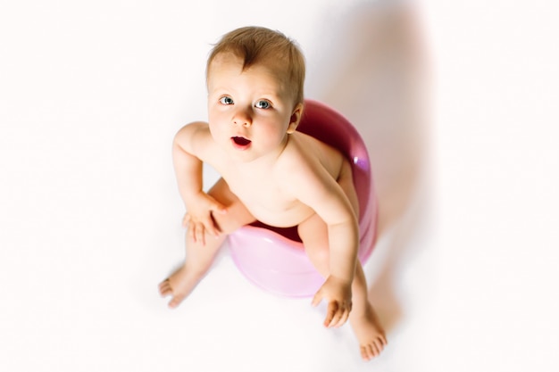 Premium Photo Baby Girl Sits On A Children S Pot Toilet On A White Background