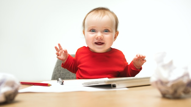  Baby  girl sitting with cup of coffee and keyboard Free Photo 