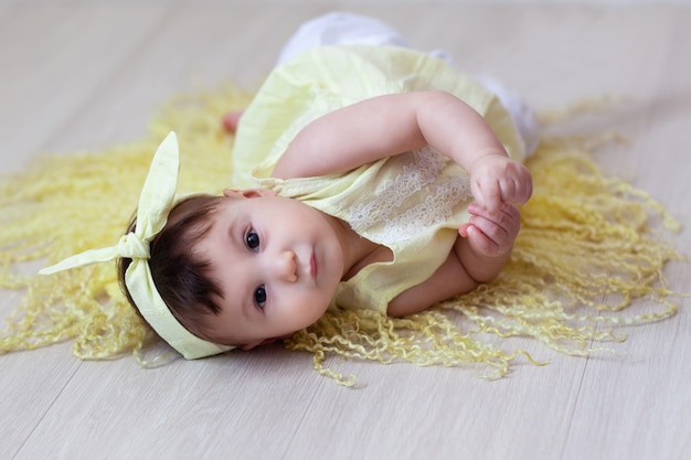 baby in yellow dress