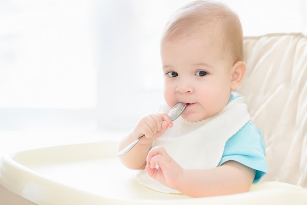 baby holding spoon