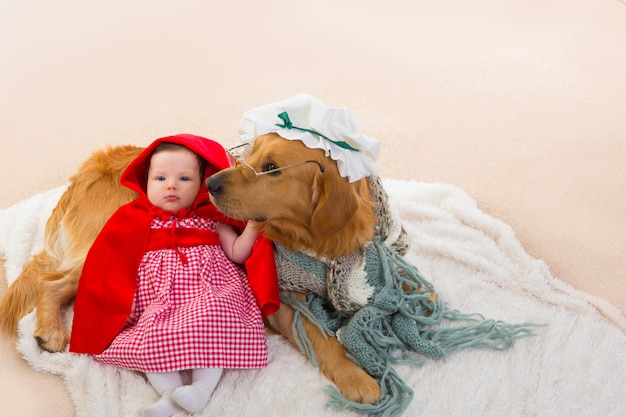 Baby Little Red Riding Hood With Wolf Dog As Grandma Premium Photo
