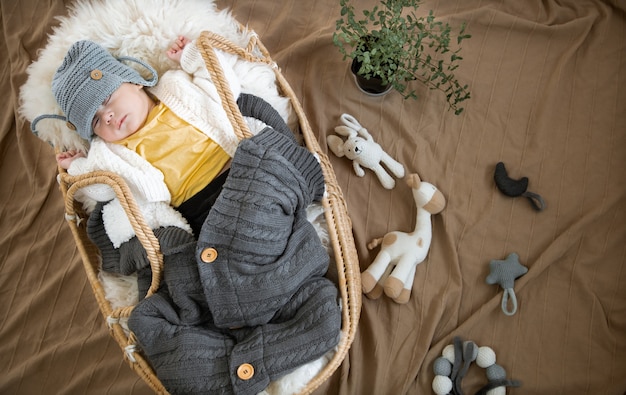 Premium Photo The Baby Sleeps Sweetly In A Wicker Cradle In A Warm