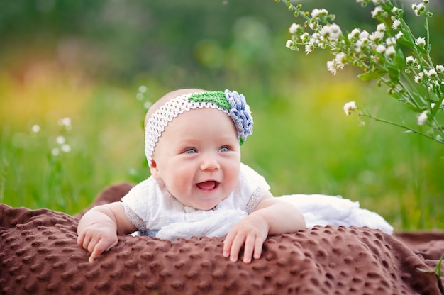 Premium Photo | Baby smiling and looking up outdoors in sunlight