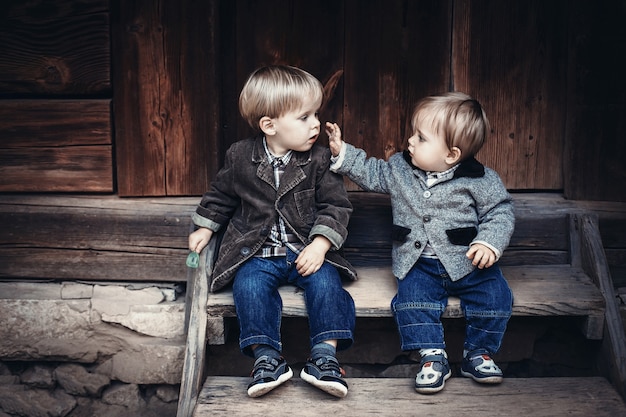 Baby touching another child's face Photo | Premium Download