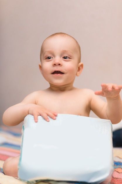 Premium Photo | Baby with package of diapers