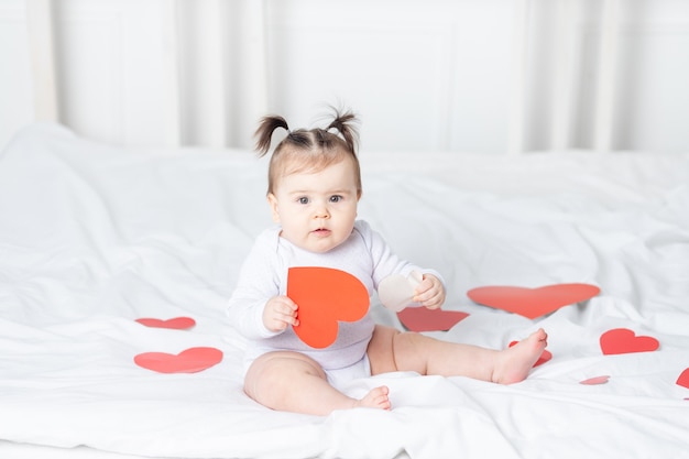 Premium Photo | Baby with red hearts, valentine's day concept