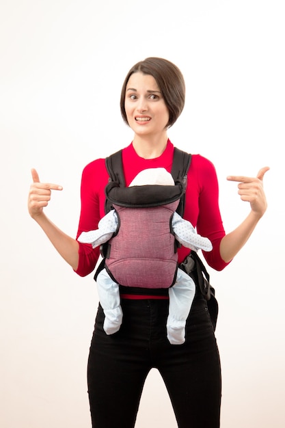Babywearing confused young mother 