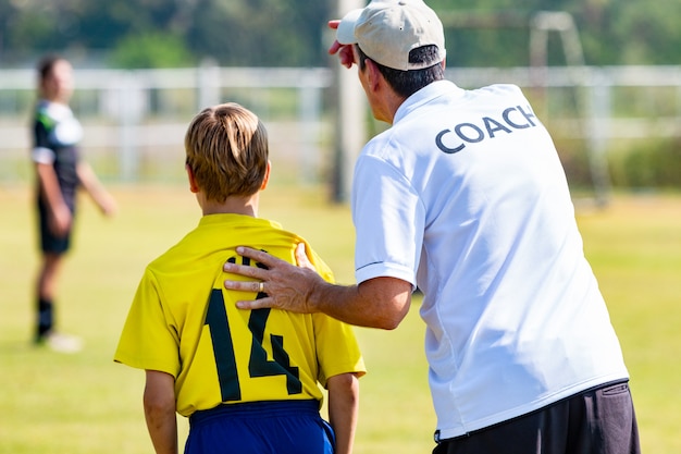 Premium Photo | Back of male football coach about to send in his young ...