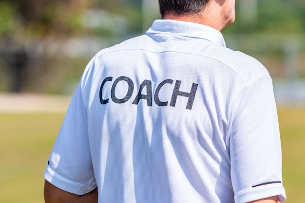 Premium Photo | Back of male sport coach wearing coach shirt at an ...