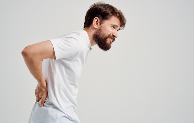 Premium Photo | Back pain young man in t-shirt beard mustache brunette