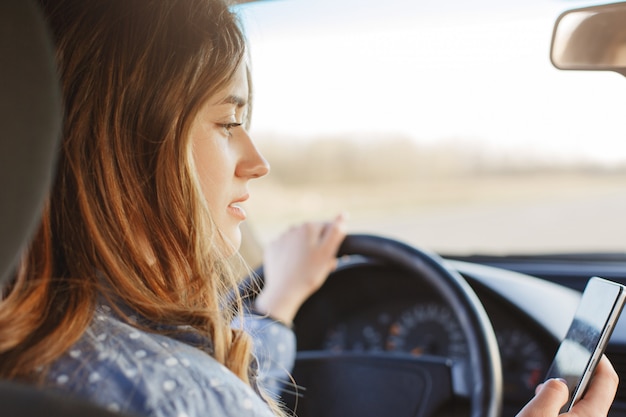 Back View Of Concentrated Female Driver Sits In Car Premium Photo