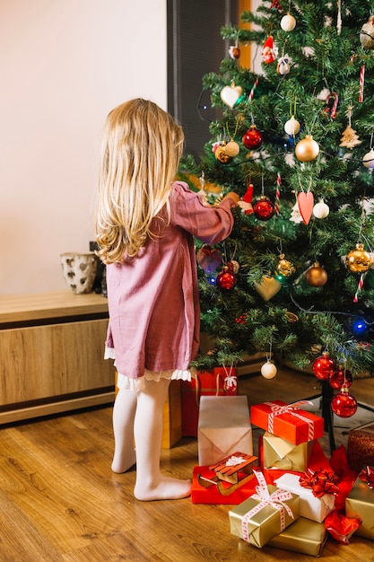 girl decorating christmas tree