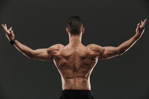 Premium Photo | Back view portrait of a young muscular bodybuilder posing