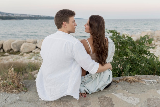 Free Photo Back View Of Romantic Couple Holding Each Other By The Ocean