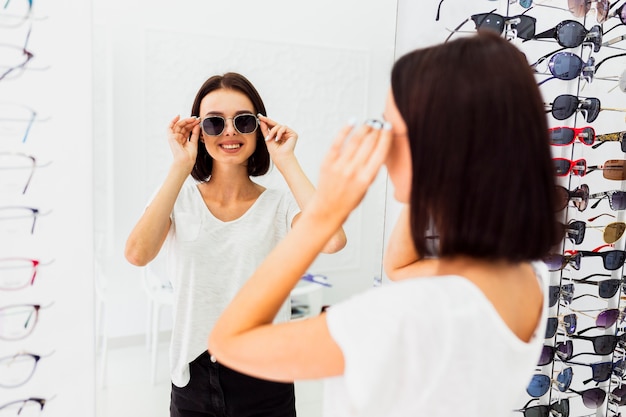 Back view of woman trying sunglasses Free Photo