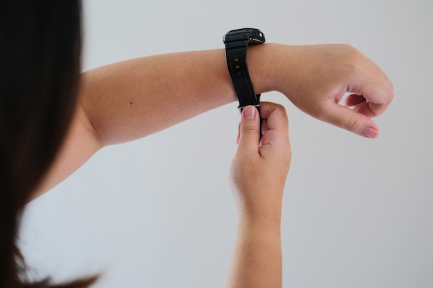 Premium Photo | Back view of woman wear her watch