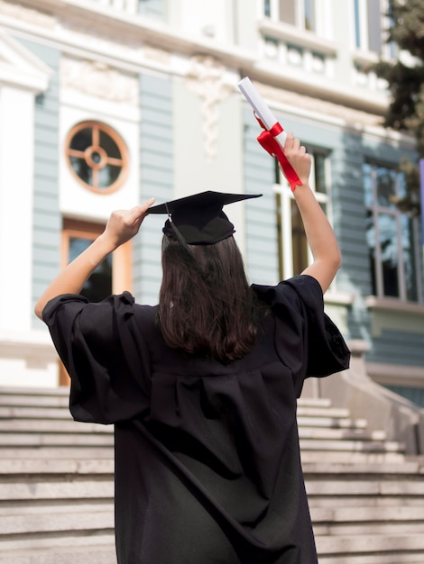 Back View Young Woman Wearing Graduation Gown Outdoors 