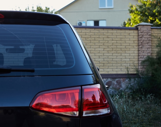 Download Premium Photo | Back window of black car parked on the street in summer sunny day, rear view ...