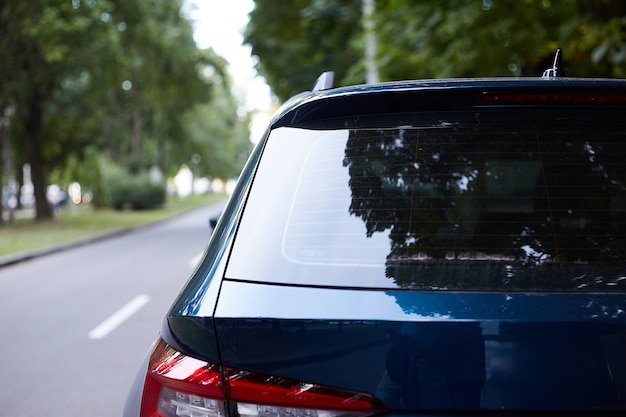 Download Premium Photo | Back window of blue car parked on the ...