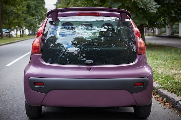 Download Premium Photo | Back window of purple car parked on the ...