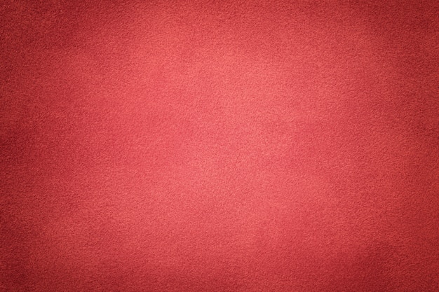 Background of dark red suede fabric closeup. velvet matte texture Premium Photo