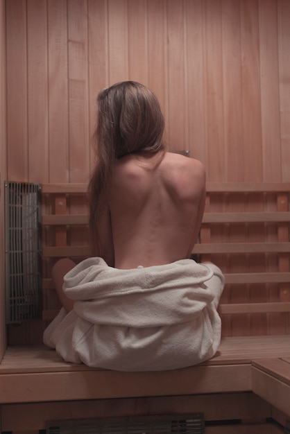 Free Photo | Backless sexy young woman sitting on bench in sauna