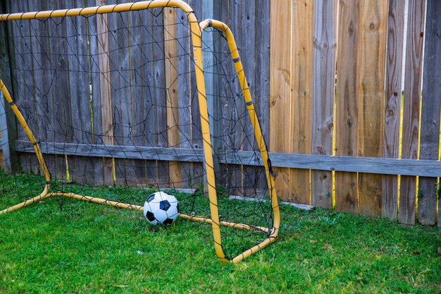 Backyard Chldren Soccer At The Wood Fence With Wall Photo