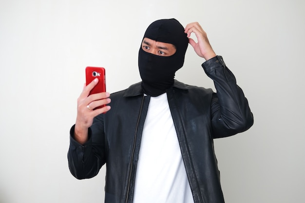 Premium Photo | Bad guy wearing balaclava showing confused gesture ...