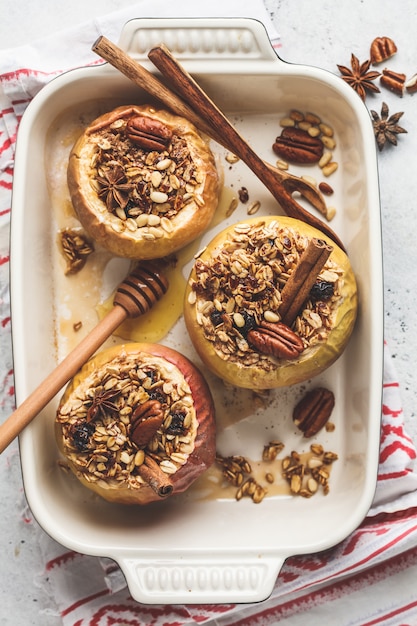 Premium Photo | Baked apples with granola, cranberries, nuts and honey
