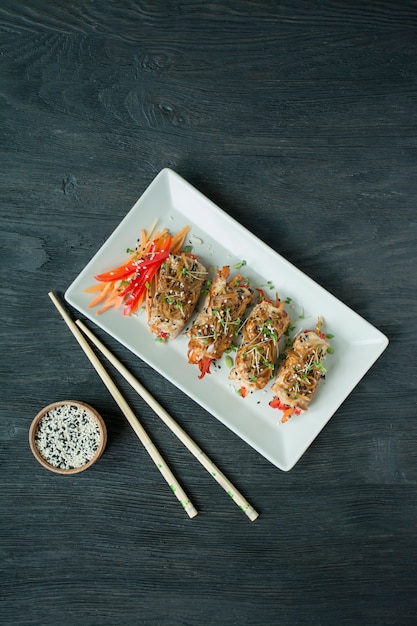 Premium Photo Baked Chicken Breast Rolls With Herbs Slices Of Carrots Bell Pepper On A Dark Cutting Board Asian Style The Balance Of Healthy Eating Cooking Dark Wooden Background