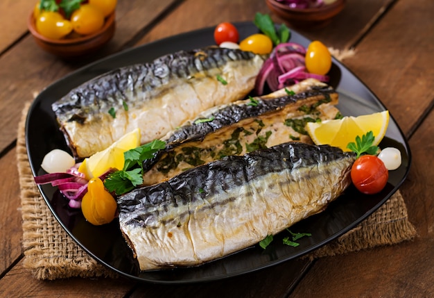 Premium Photo | Baked mackerel with herbs and garnished with lemon and ...