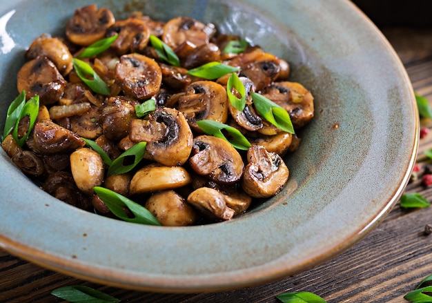 Baked mushrooms with soy sauce and herbs. vegan food. Free Photo
