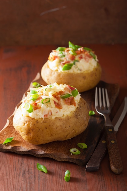 Premium Photo | Baked potato in jacket with bacon and cheese