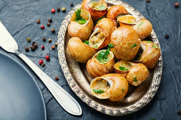 Premium Photo | Baked snails.snails in vintage tray.stuffed escargots ...