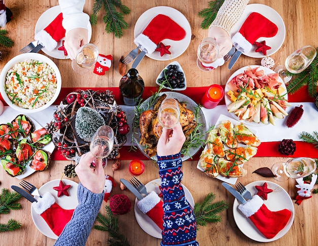 Free Photo | Baked turkey. christmas dinner. the christmas table is served  with a turkey, decorated with bright tinsel and candles. fried chicken,  table. family dinner. top view, hands in the frame
