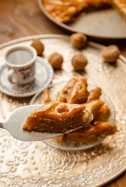 Premium Photo | Baklava with nuts on a wooden background. selective focus.