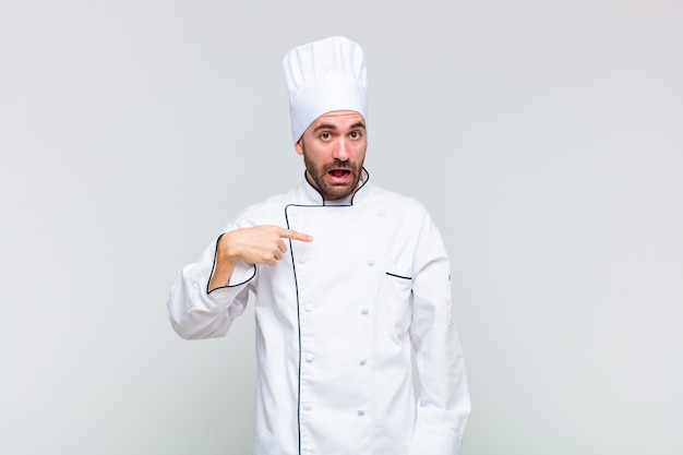 Premium Photo | Bald man looking happy, proud and surprised, cheerfully ...