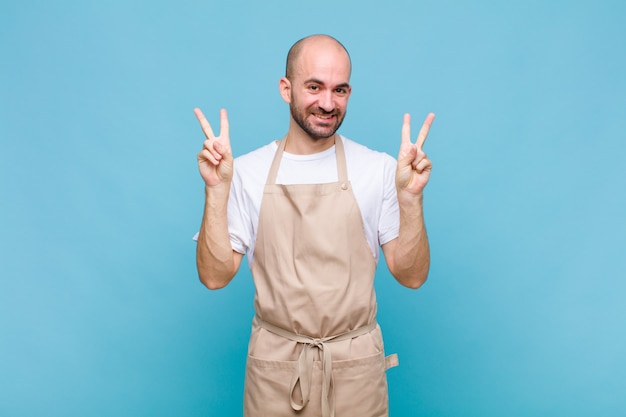 Premium Photo | Bald man smiling and looking happy, friendly and ...