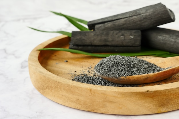 Premium Photo | Bamboo charcoal and powder on marble table.